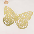 Gold decorative butterfly cutout with intricate design on white background