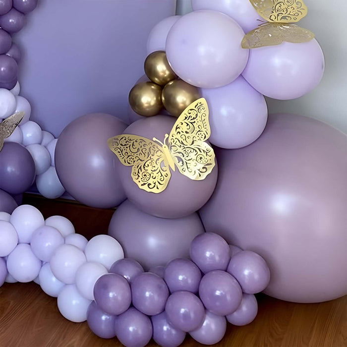 Purple balloons with gold butterfly accents in a festive arrangement.