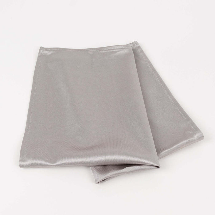 Silver satin fabric folded neatly on a white background.