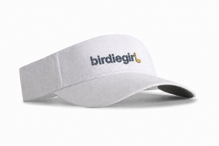 A white visor-style hat with the text 'birdiegirl' embroidered on the front in  light blue with a terracotta golf club.