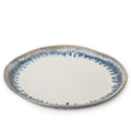 The Simon Pearce Burlington Dinnerware Pool is a round ceramic plate with a glazed, slightly uneven edge, a white center, and a blue-gray speckled rim, shown against a plain white background.