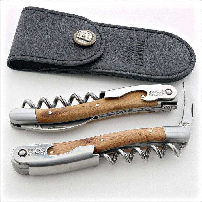 Chateau Laguiole Classic Juniper Corkscrew, top-down view of two corkscrews with juniper wood handles and a black leather pouch. Handcrafted details, 100% Made in France.