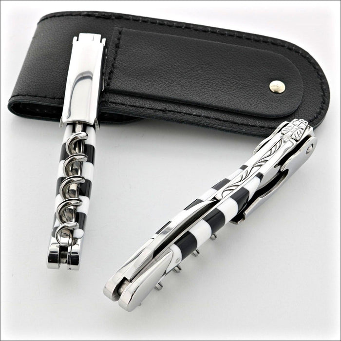 Chateau Laguiole Grand Cru Damier Corkscrew, close-up of two corkscrews with black and white striped handles. Handcrafted details, 100% Made in France.