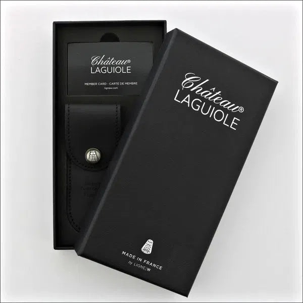 Chateau Laguiole Grand Cru Damier Corkscrew, top-down view of black gift box with corkscrew in leather pouch and member card. Handcrafted details, 100% Made in France.