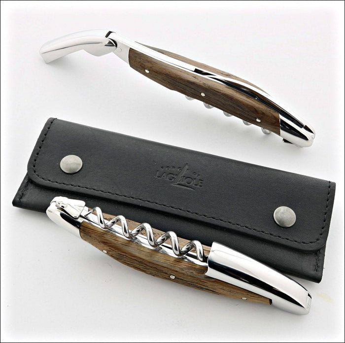 Forge de Laguiole corkscrew, top-down view showing sub-fossilized oak handle, shiny steel, and case.