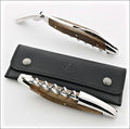 Forge de Laguiole corkscrew, top-down view showing sub-fossilized oak handle, shiny steel, and case.