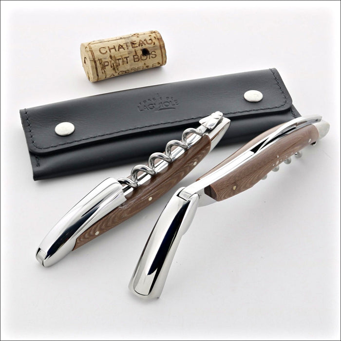 Forge de Laguiole Corkscrew, close-up of chocolate compressed fabric handles, steel, and leather case.