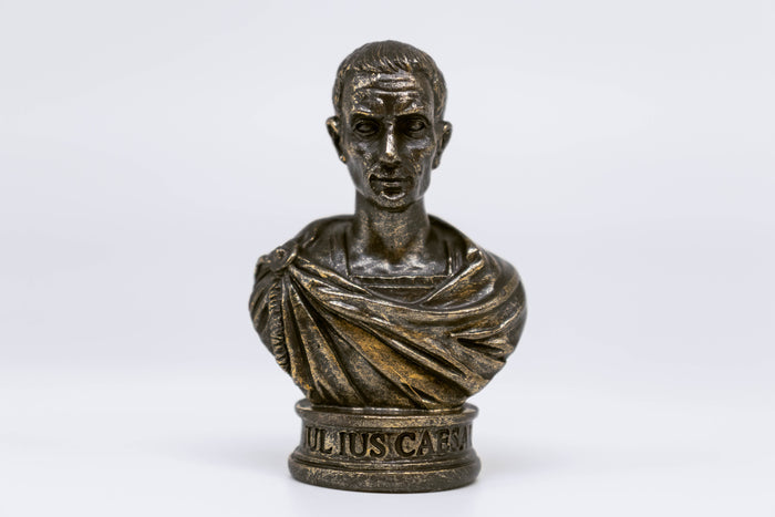 Straight-on front view of Caesar bust, inscription reads "Julius Caesar" on the bust which is fully visible, white background.