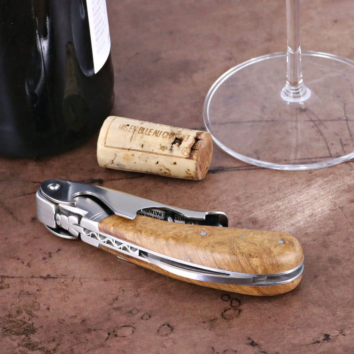 Laguiole Magnum Amboyna Burl Corkscrew, close-up of light brown burl wood handle and metal details.