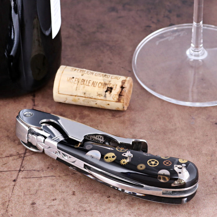 Laguiole Magnum Corkscrew close-up featuring a black handle with intricate gold timepiece gear inlay.