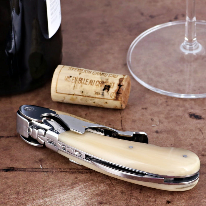 Laguiole Magnum Horn Tip Corkscrew, close-up of cream horn handle, polished steel, wine bottle, cork.
