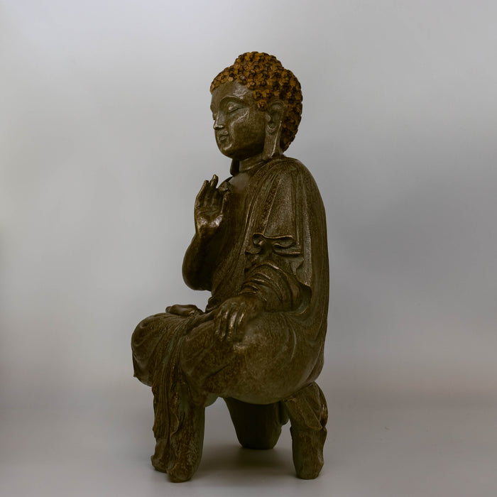 Side angle view of Buddha Siddhartha statue, bronze color, on white background.