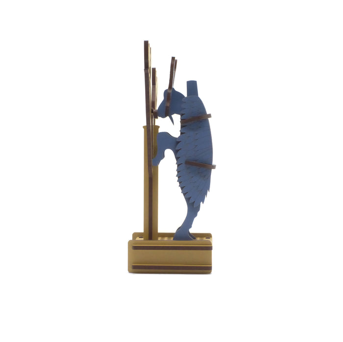 Assembled 3-d puzzle of a ram on a gold/yellow color stand against a white background. Side view.